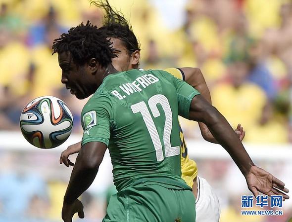 6月19日，科特迪瓦队球员维?博尼（前）与哥伦比亚队球员争抢。当日，在巴西首都巴西利亚马内?加林查国家体育场进行的2014年巴西世界杯小组赛C组比赛中，哥伦比亚队对阵科特迪瓦队。 新华社记者戚恒摄