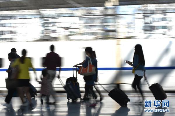 10月1日，旅客在安徽合肥火车站乘车。据铁路、交通部门消息，“十一”黄金周假期首日，全国铁路迎来客流最高峰，预计铁路发送旅客突破1100万人次，道路旅客运输预计客流量达到9700万人次。新华社发（杨晓原 摄）