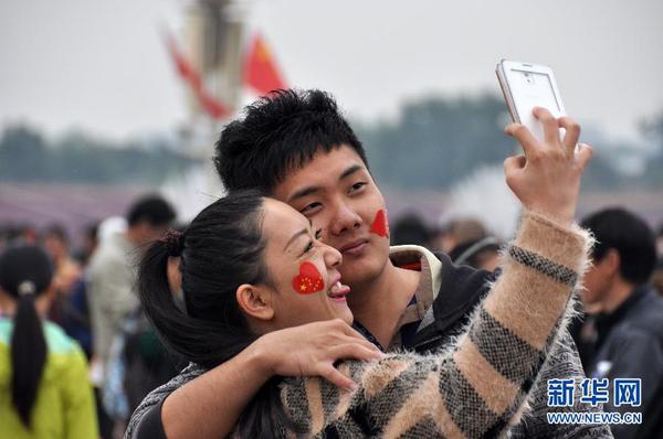 10月1日，一对年轻人在天安门广场自拍。