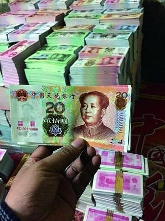 在印刷厂车间内，仿制市面流通的第五版人民币的冥币成堆摆放