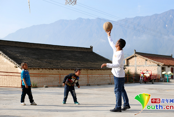 　清晨，黄三英早早地来到学校前的空地，陪孩子们打球、玩耍?！白羁炖值氖露褪堑搅搜?，和孩子们在一起?！被迫⑺?。中国青年网记者 张炎良 摄