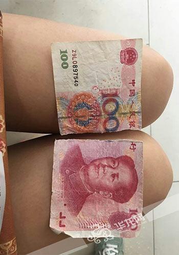 被“摩的”司机撕成两半的“假钞”。沙坪坝警方供图