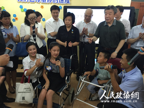 调研组听长春市宽城区培智学校的师生演唱他们自己作词作曲的《为爱而来》，感动不已。