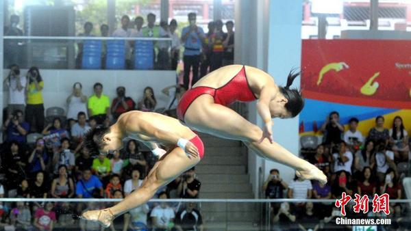 8月28日，里约奥运内地精英运动员代表团继续访港行程，部分运动员维园游泳池示范跳水。图为吴敏霞与陈艾森示范跳水。 中新社记者 谭达明（香港分社） 摄