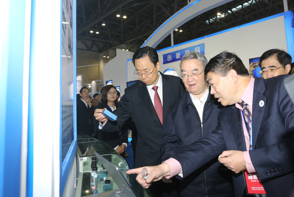 二、桑国卫副委员长（中）在蓝绍敏书记（左一）等领导陪同下在医博会展示区饶有兴趣地参观。摄影／ 顾俊 刘燕