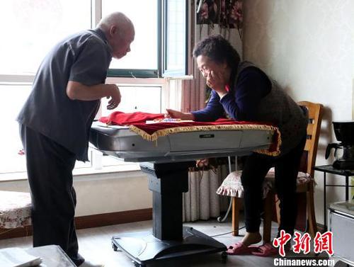 图为潘绍斌夫妇正在玩跳棋。　张海雯 摄