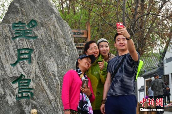 4月3日下午，河北安新县“华北明珠”白洋淀游人如织，图为北京游客拍照留影。<a target='_blank' href='http://www.chinanews.com/'>中新社</a>记者 翟羽佳 摄