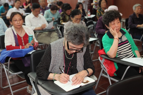 老人们在认真记笔记。