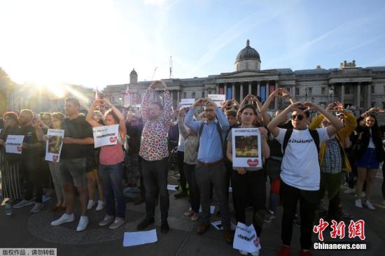 当地时间5月23日，英国伦敦特拉法加广场，民众向天空比心，悼念曼彻斯特爆炸遇难者。