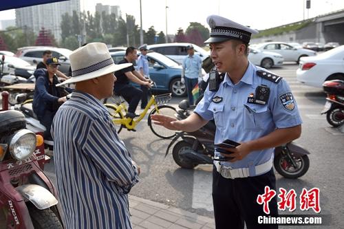 6月21日上午，北京交警敖翔正在处理交通违法行为。<a target='_blank' href='http://www.chinanews.com/' >中新网</a>记者 金硕 摄