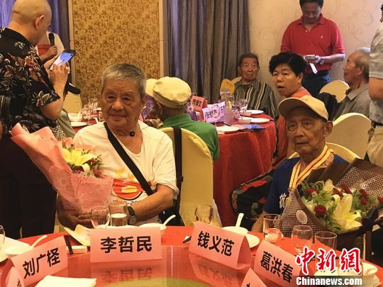 志愿者为抗战老兵献上鲜花?！⊙钛沾?摄
