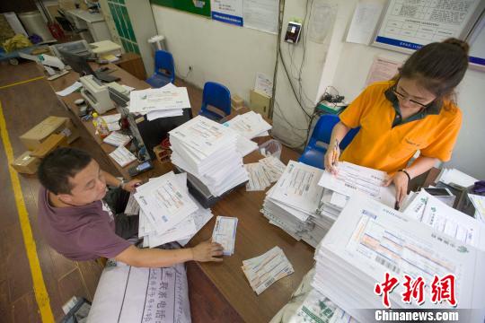 资料图：物流业工作人员正在录入快递信息?！≌旁?摄