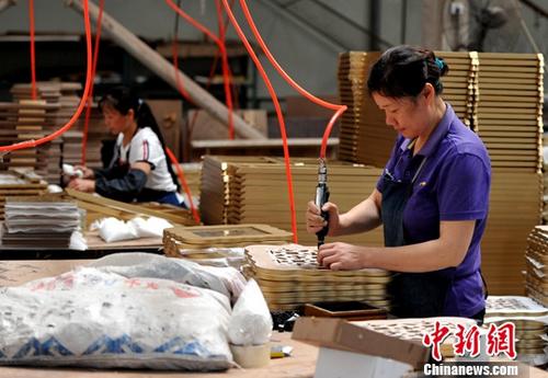 7月17日，中国国家统计局发布的数据显示，上半年，中国居民人均可支配收入12932元人民币，扣除价格因素实际增长7.3%，增速比一季度加快0.3个百分点，比上年同期加快0.8个百分点；GDP同比增长6.9%，低于居民人均可支配收入增长0.4个百分点。图为厦门一企业生产车间，工人正在流水线上作业。(资料图片) <a target='_blank' href='http://www.chinanews.com/'>中新社</a>记者 张斌 摄