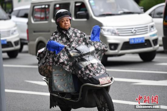 资料图：8月30日，成都市民增添衣物出行。。 <a target='_blank' href='http://www.chinanews.com/'>中新社</a>记者 张浪 摄