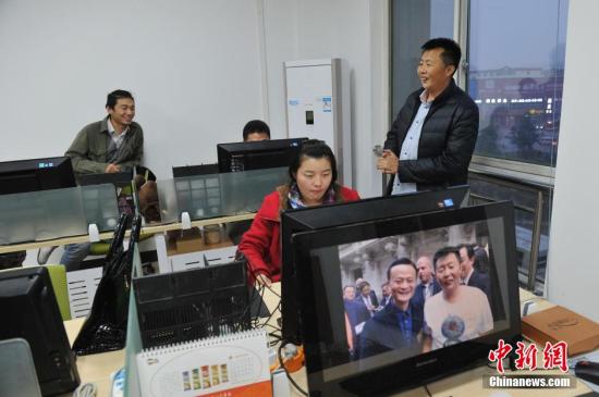 资料图：农民电商王小帮与加班的员工聊天。 <a target='_blank' href='http://www.chinanews.com/'>中新社</a>记者 韦亮 摄