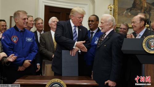 资料图片:美国总统特朗普在白宫和前宇航员握手. 点击进入下一页