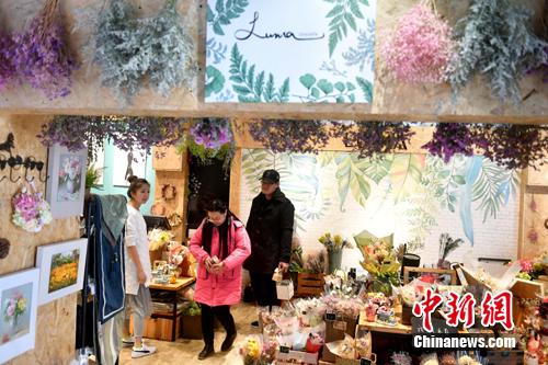 图为李函儒招呼店里的顾客。 吕明 摄