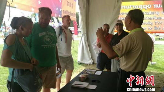 图为在2018美国通航展“中国馆”交流的通用航空爱好者?！°菩癫?摄