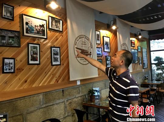 胡里山炮台管理处主任王勇介绍改造一新的瞭望台战地服务部内文化墙富装饰。杨伏山 摄