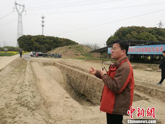 周润垦在介绍发掘出的古河道遗址?！≈由?摄