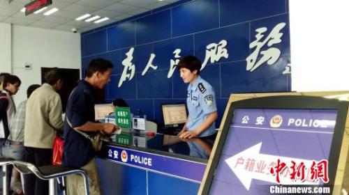 图为民众在公安派出所办理城镇落户手续?！⊙罟庹?摄