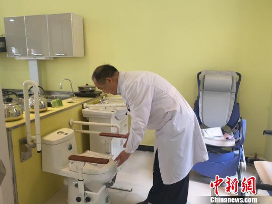 图为甘肃省辅具中心主任王应良进行残障人辅助工具用途的讲解。　高康迪 摄