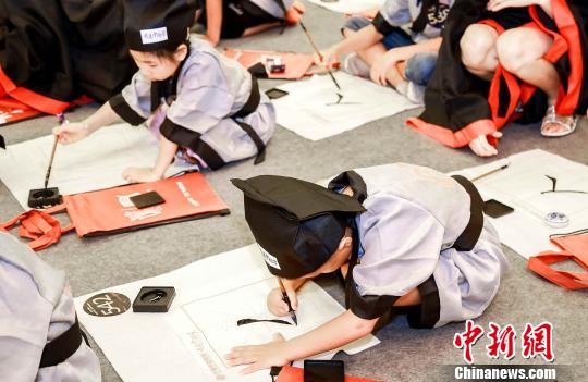 小朋友开笔书写“人”字。供图