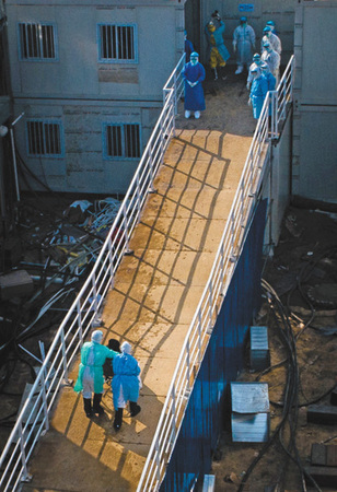 1 4日，医护人员将患者送入火神山医院病房。