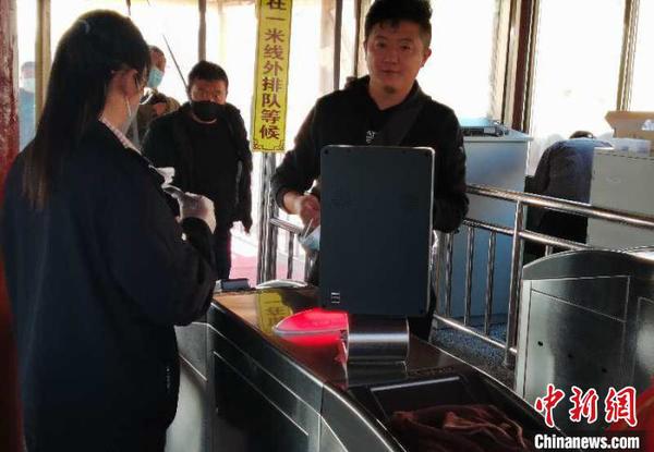 图为游客进景区前测量体温。甘肃嘉峪关市文旅局供图