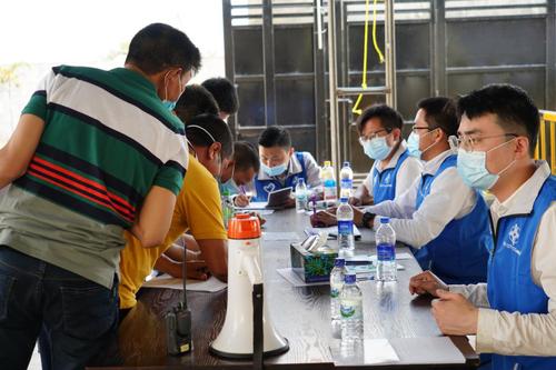 4月6日，在科伦坡港口城接种点，“蓝马甲”志愿者为前来接种的中国公民进行登记。新华社记者 唐璐 摄